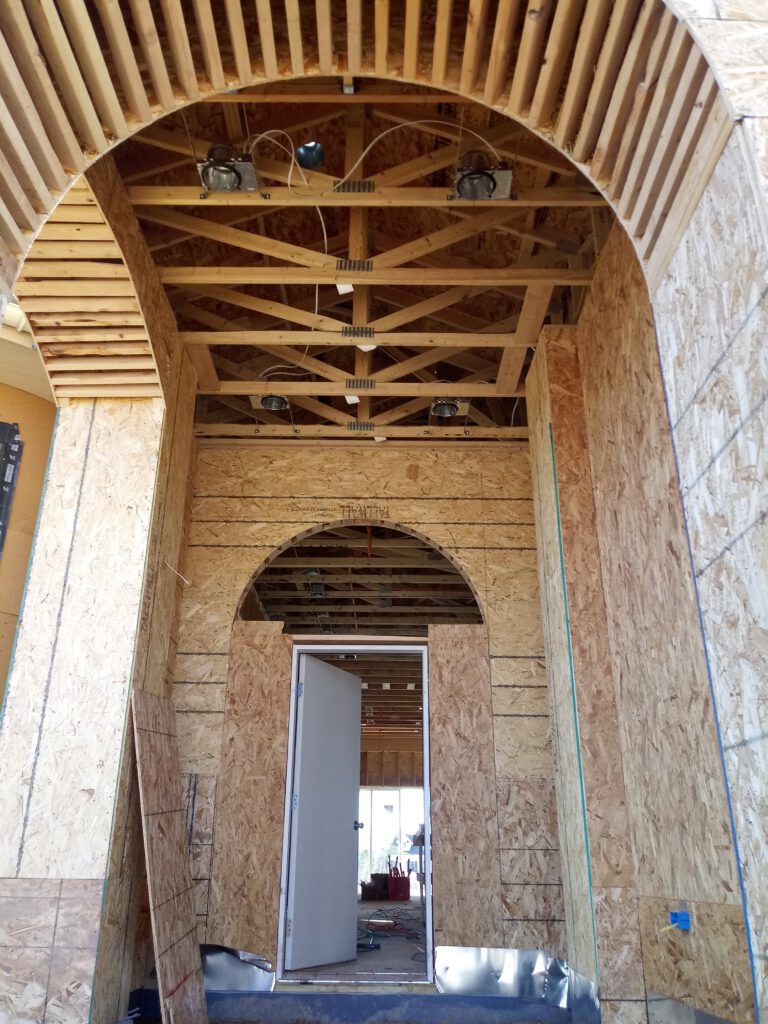 Sheathed arched opening, framed by LX