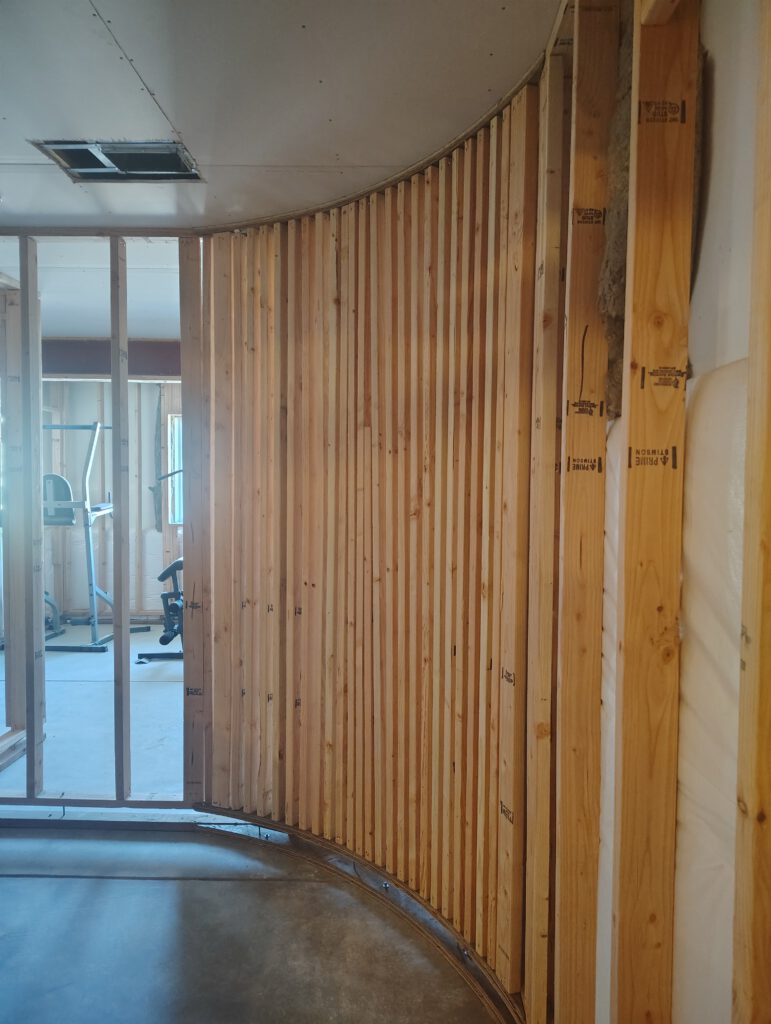 Curved basement wall, framed by LX