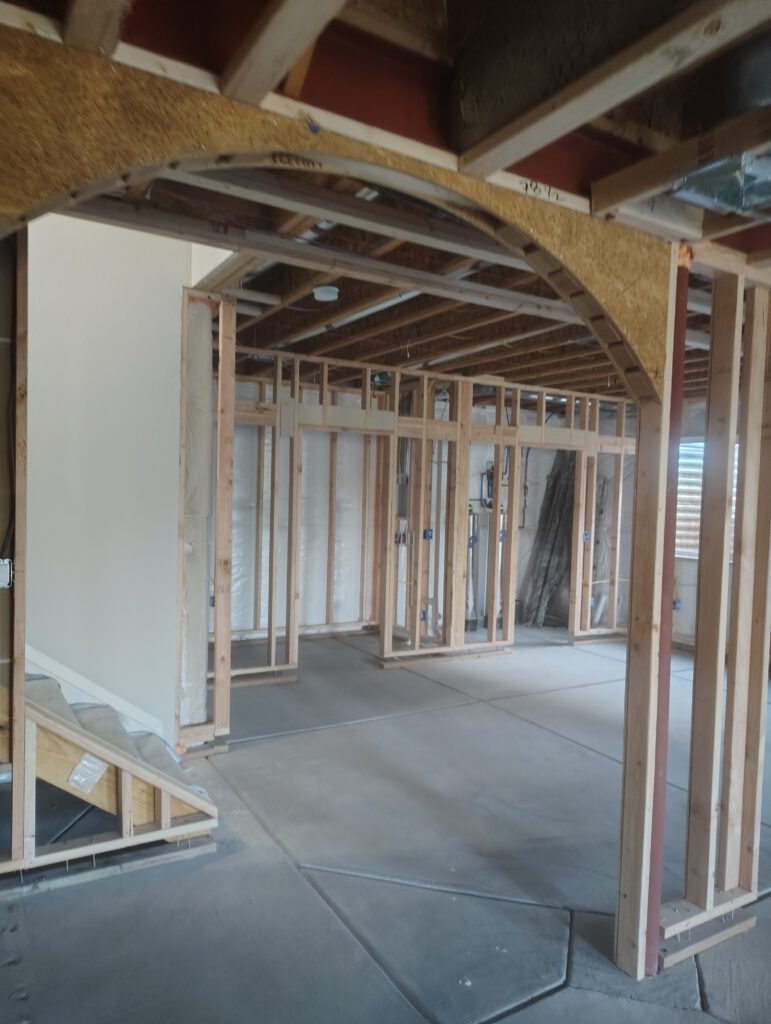 Arched openings in a basement, framed by LX